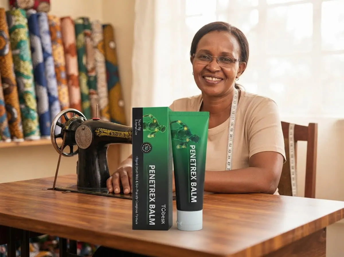 Penetrex Balm Kenya: smiling tailor at an old sewing machine with fabrics behind him, a busy Kenyan working day